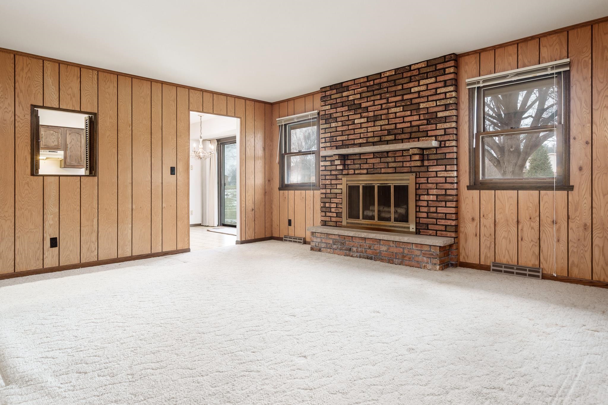 8169 Clockview Road Rockford, IL 61108 - Photo 13 of 34 an empty room with windows fireplace and windows