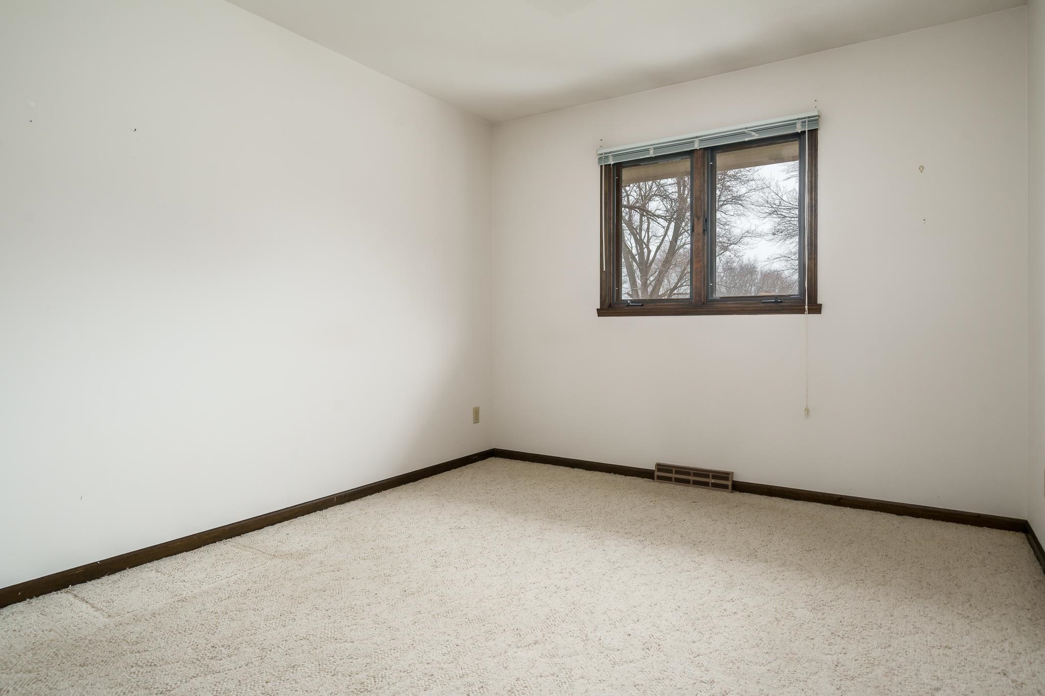 8169 Clockview Road Rockford, IL 61108 - Photo 18 of 34 an empty room with a window