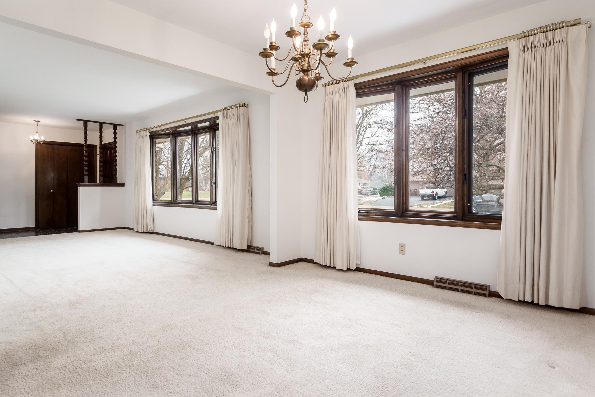 8169 Clockview Road Rockford, IL 61108 - Photo 6 of 34 a view of an empty room with a window and chandelier fan
