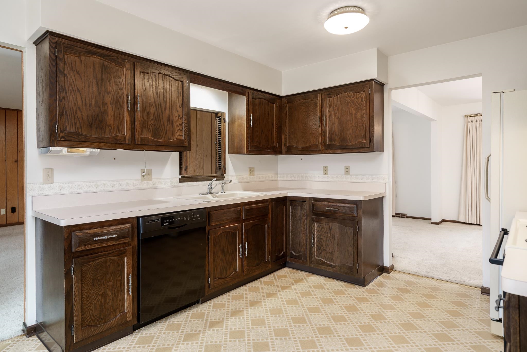 8169 Clockview Road Rockford, IL 61108 - Photo 9 of 34 a kitchen with a sink cabinets and a window