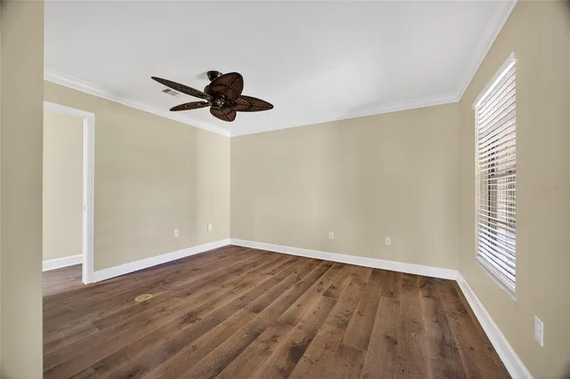 wooden floor in an empty room with a window