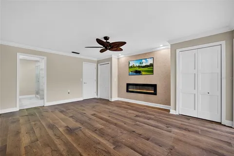 a view of empty room with wooden floor and window