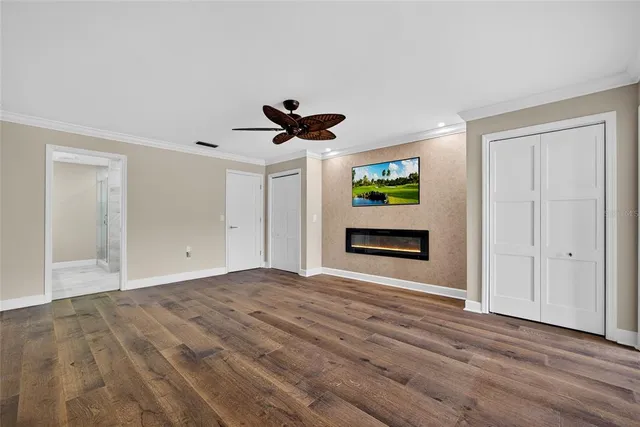 a view of empty room with wooden floor and window