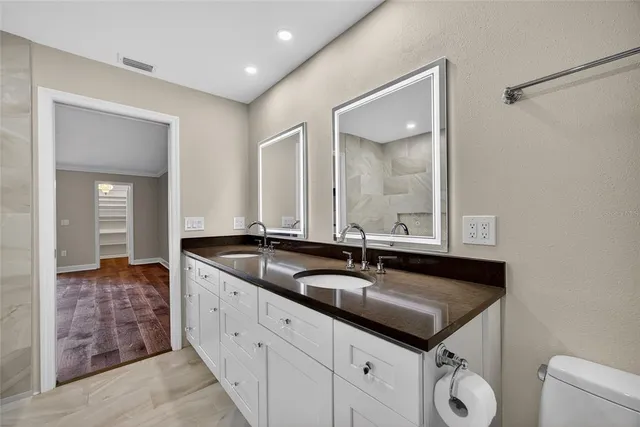 a bathroom with a granite countertop sink and a mirror