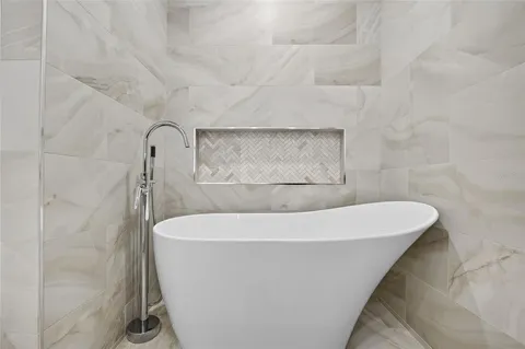 a white bath tub sitting in a bathroom
