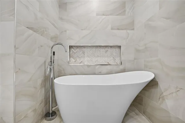 a white bath tub sitting in a bathroom