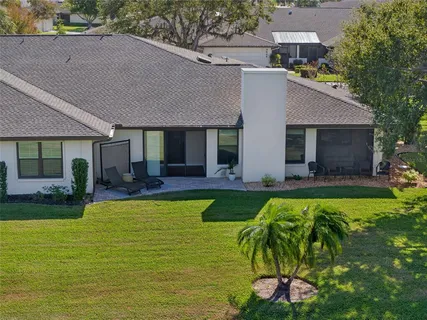 a view of house with swimming pool yard and outdoor seating