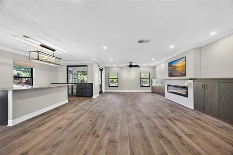 a view of a kitchen with a sink cabinets and wooden floor