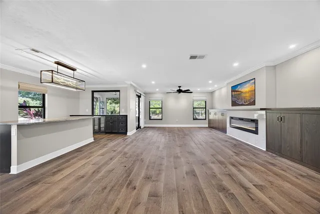 a view of a kitchen with a sink cabinets and wooden floor