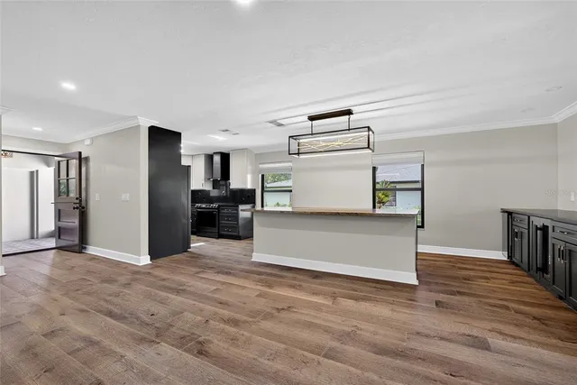a view of a kitchen with furniture and wooden floor