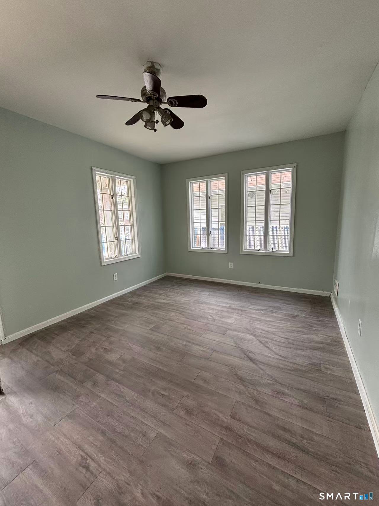 366 Dover Street Bridgeport, CT 06610 - Photo 3 of 15 a view of an empty room with wooden floor and a window