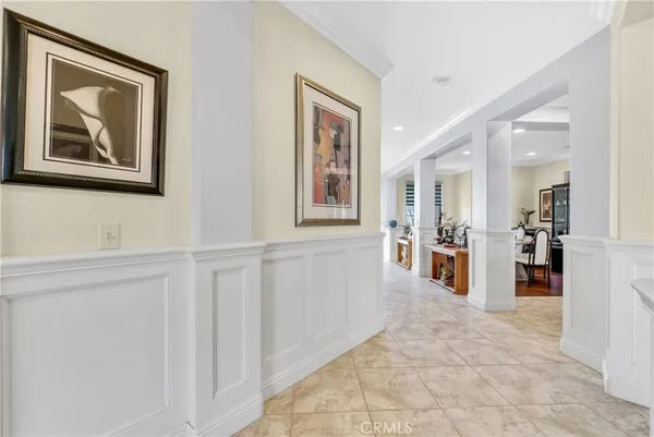 a living room with stainless steel appliances a dining table and kitchen view