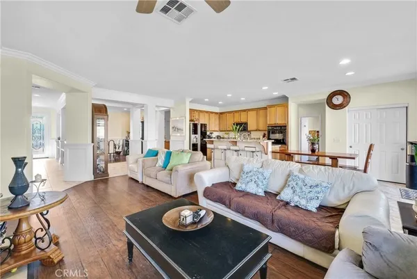 a living room with furniture a kitchen view and a kitchen view