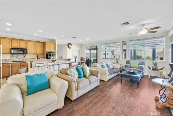 a kitchen with stainless steel appliances granite countertop a stove a sink a microwave a refrigerator and cabinets