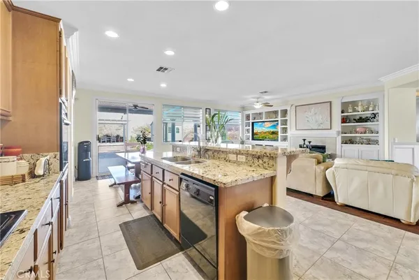 a kitchen with stainless steel appliances granite countertop a sink stove and cabinets