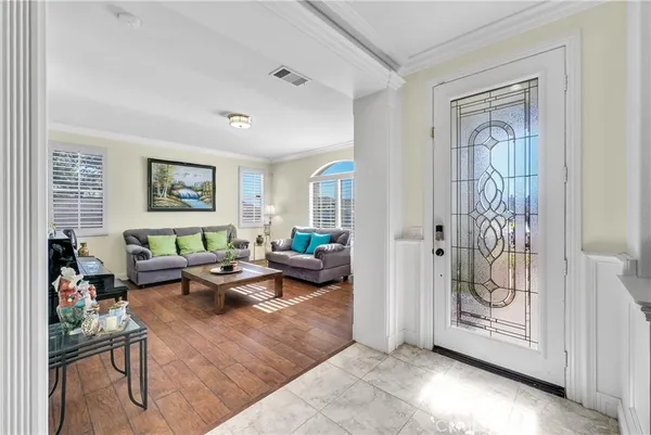 a living room with furniture a rug and a window