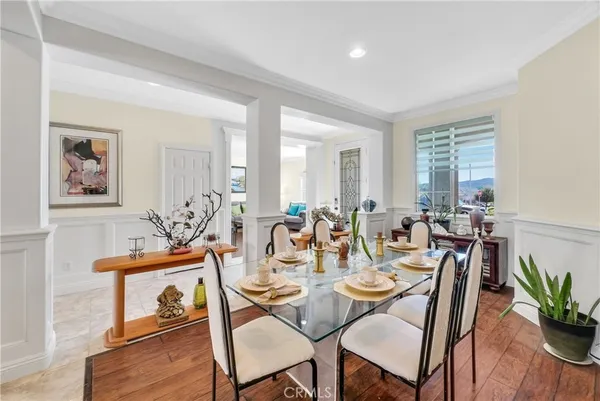 a living room with furniture kitchen and a table