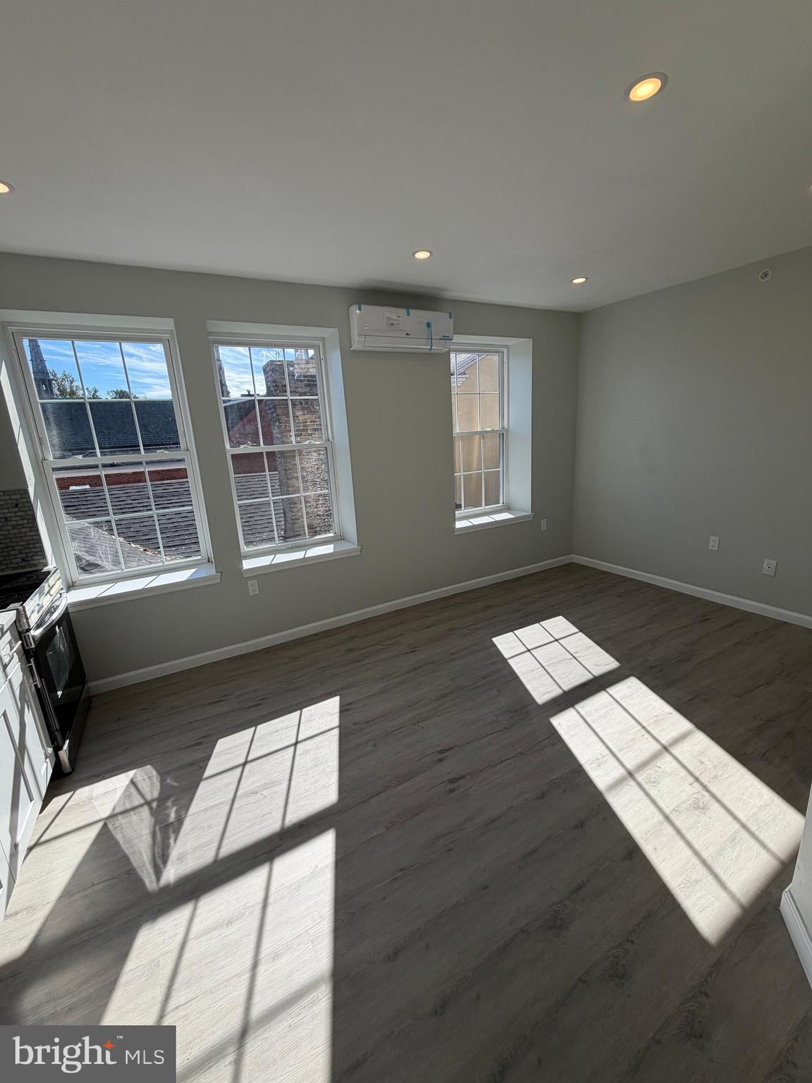 6035 Germantown Avenue, Unit 3R Philadelphia, PA 19144 - Photo 3 of 12 a view of an empty room with wooden floor and windows