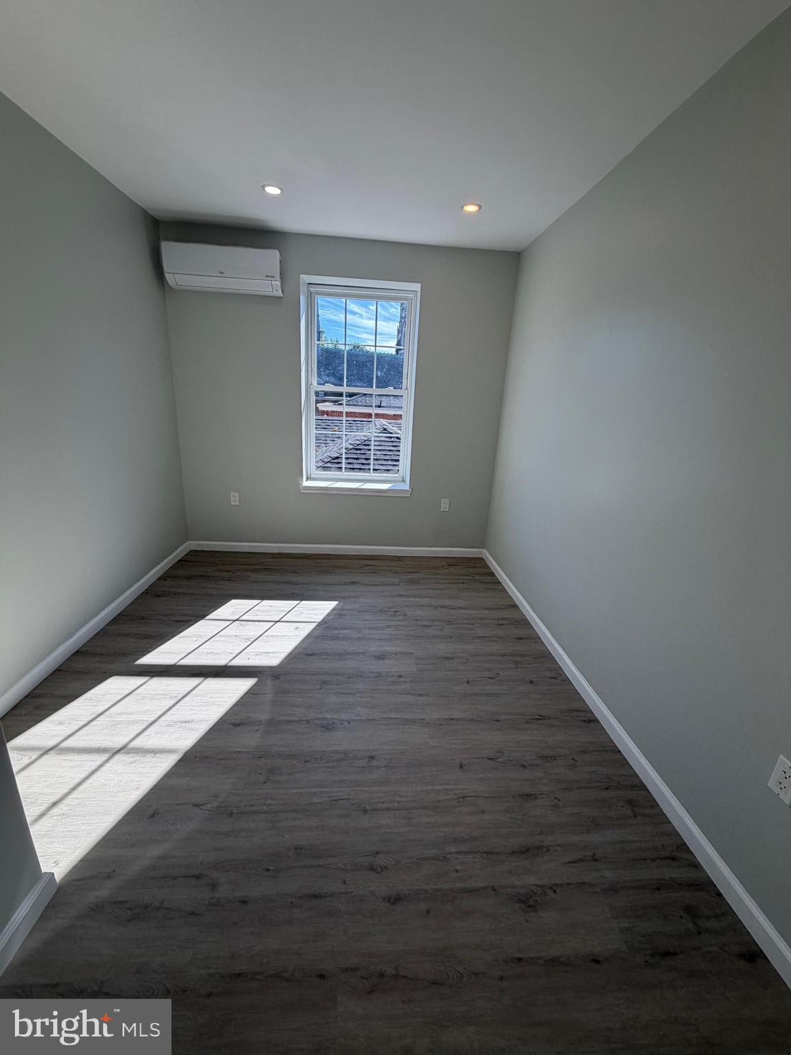 6035 Germantown Avenue, Unit 3R Philadelphia, PA 19144 - Photo 5 of 12 an empty room with wooden floor and windows