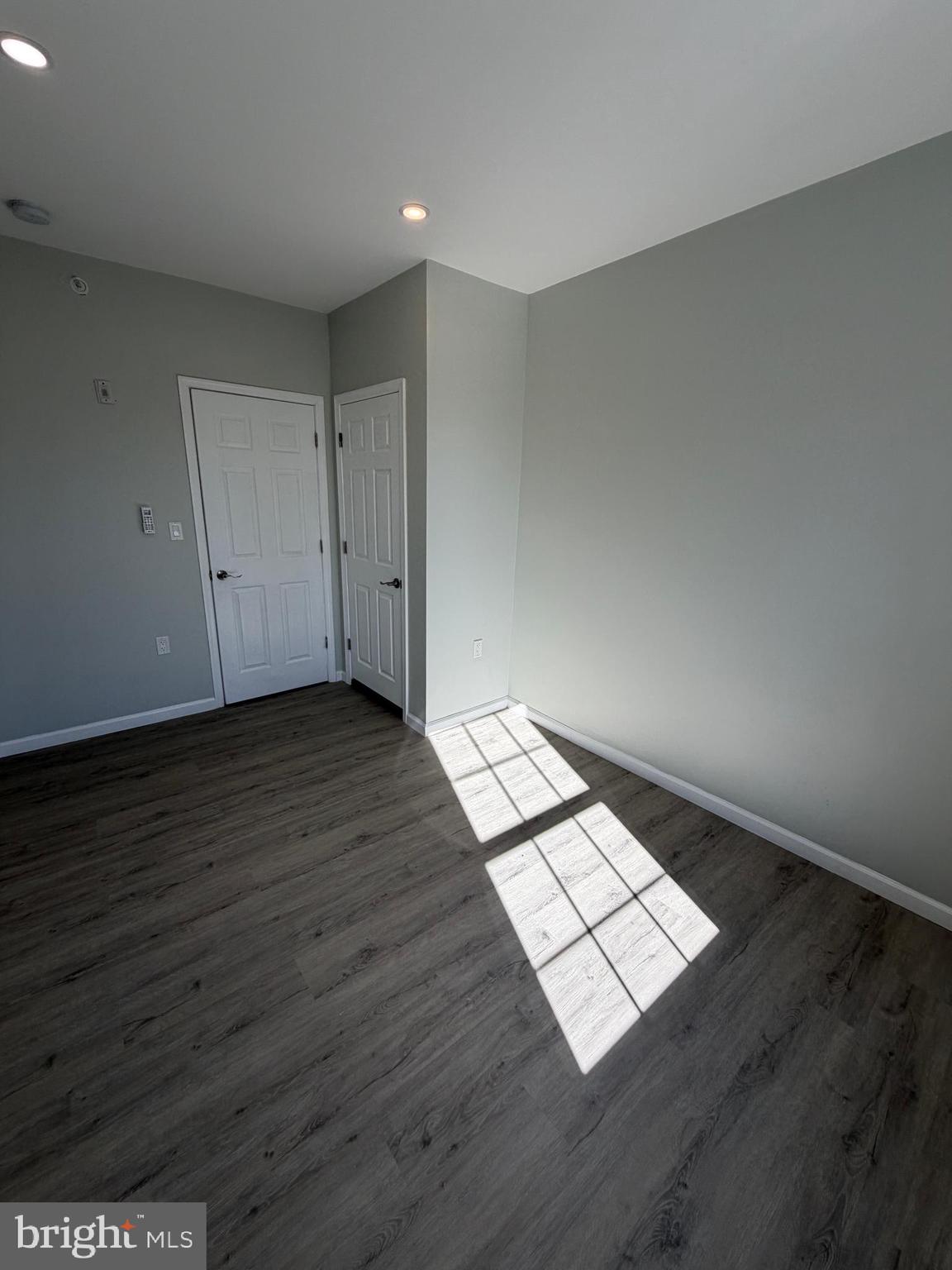 6035 Germantown Avenue, Unit 3R Philadelphia, PA 19144 - Photo 7 of 12 an empty room with wooden floor and windows