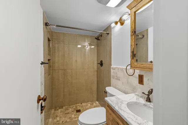 a view of a bathroom with a tub and shower