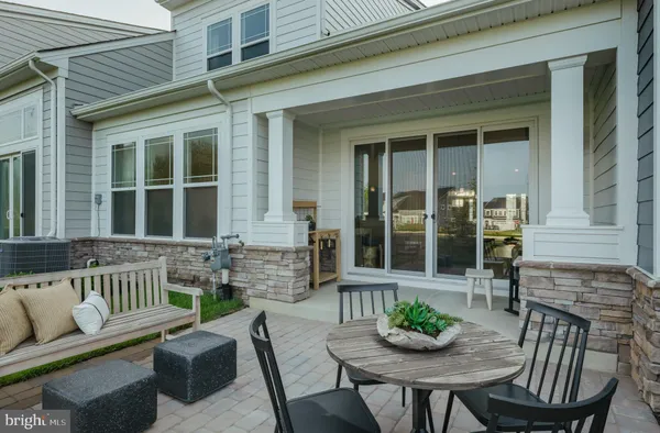 a view of a patio that has table and chairs with potted plants