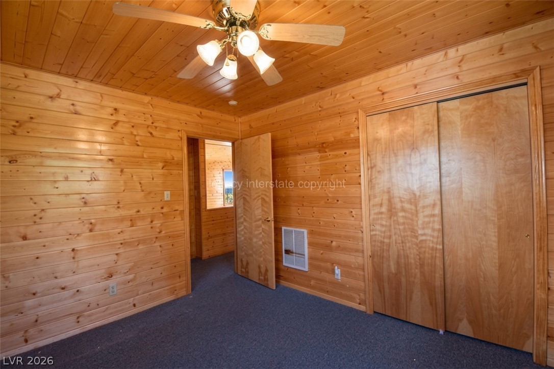 1129 East Ponderosa Road Hatch, UT 84735 - Photo 24 of 47 Rich wood plank walls and matching ceilings create a warm lodge atmosphere in this bedroom.