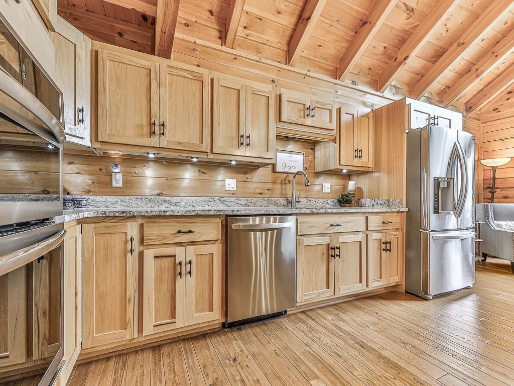 1670 Outback Road Jasper, GA 30143 - Photo 14 of 75 a kitchen with stainless steel appliances granite countertop a sink a stove a refrigerator and cabinets