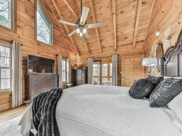 a bed room with a bed and large windows
