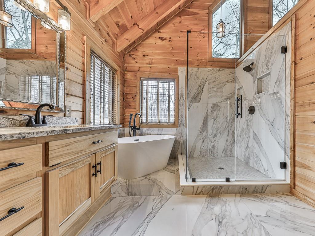 1670 Outback Road Jasper, GA 30143 - Photo 23 of 75 a bathroom with a granite countertop sink a mirror and a shower