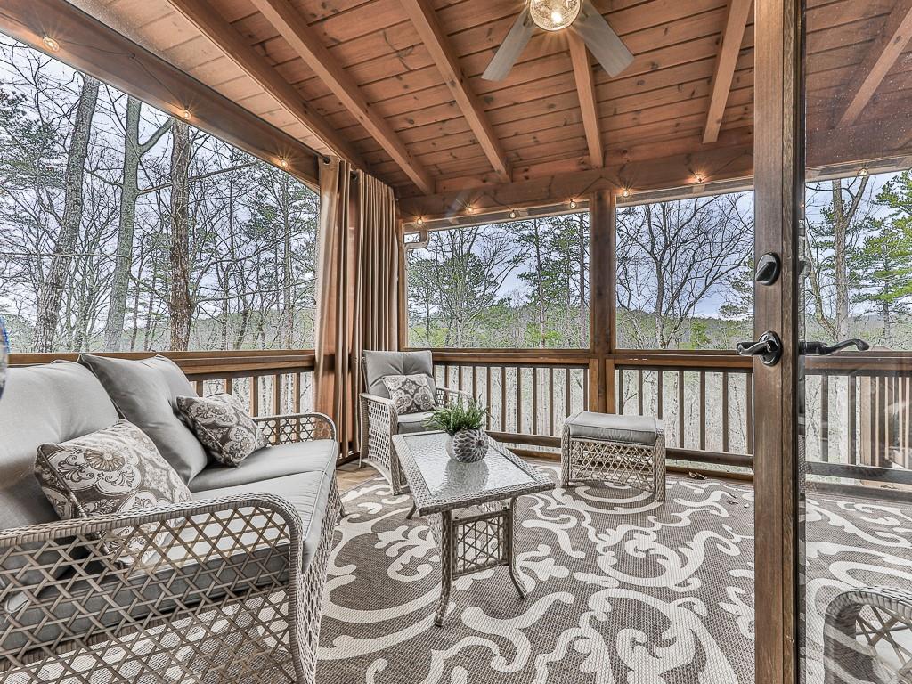 1670 Outback Road Jasper, GA 30143 - Photo 27 of 75 a living room with furniture and a floor to ceiling window