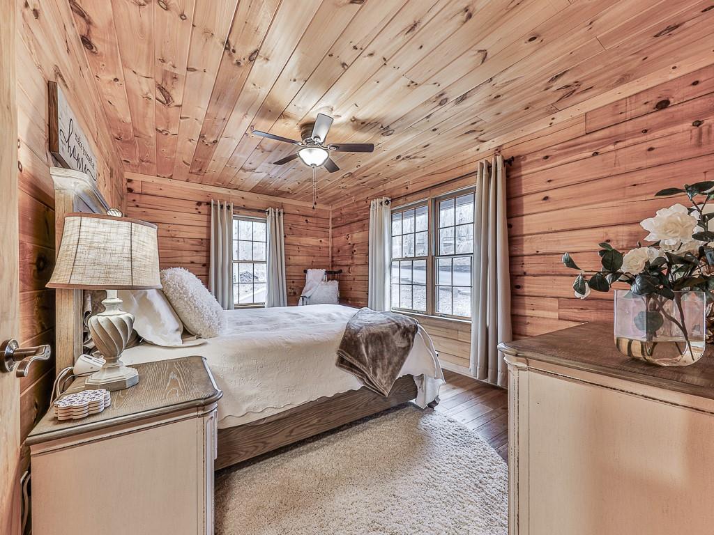 1670 Outback Road Jasper, GA 30143 - Photo 28 of 75 a bed room with a bed and large windows