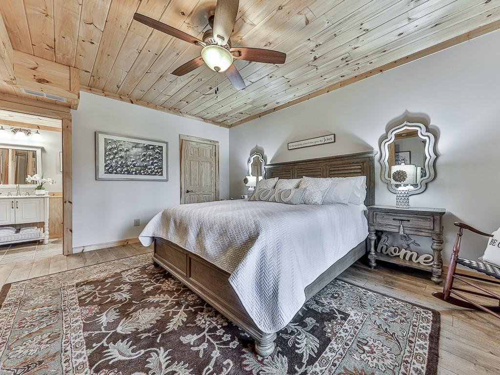1670 Outback Road Jasper, GA 30143 - Photo 40 of 75 a bedroom with a bed and wooden floor