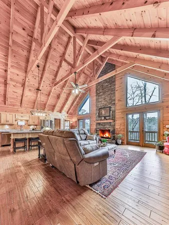 a view of a kitchen with stainless steel appliances wooden floor and living room