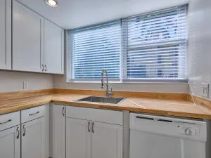 a kitchen with a sink cabinets and window