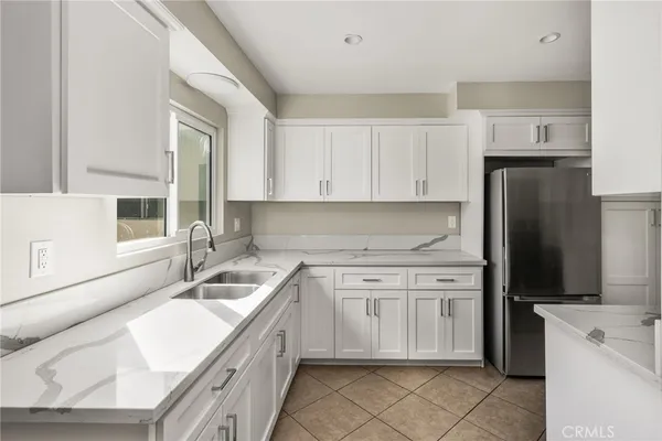 a kitchen with a sink cabinets and stainless steel appliances