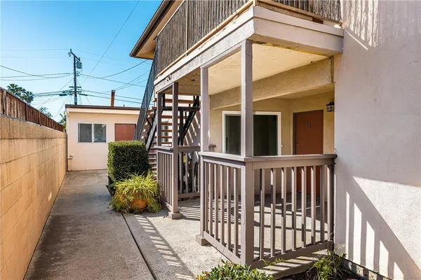 a view of a house with wooden fence