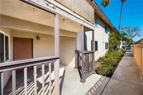 a view of a house with wooden fence