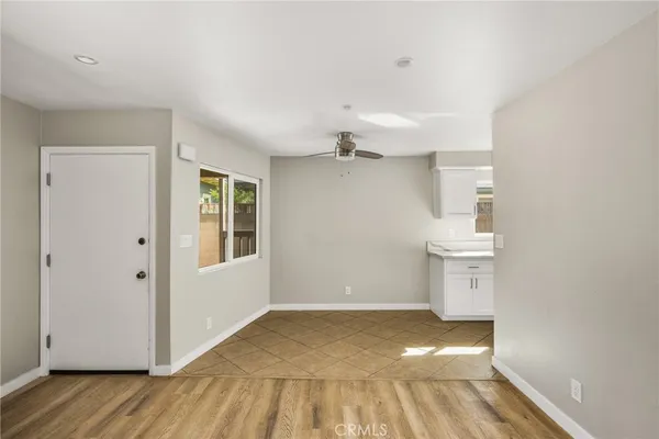 a view of a room with wooden floor and window