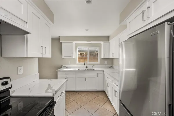 a kitchen with a sink stove and refrigerator