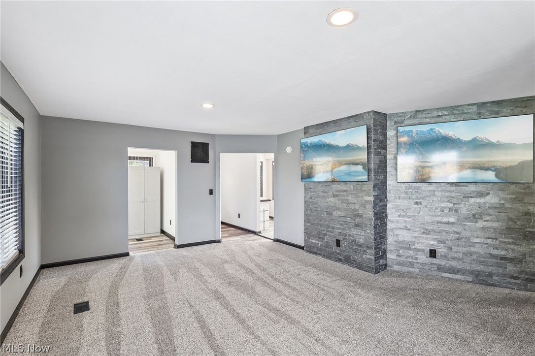 5490 Springlake Road Northwest Canton, OH 44718 - Photo 28 of 50 Room featuring light gray carpet flooring, and multiple windows with lake views and dark