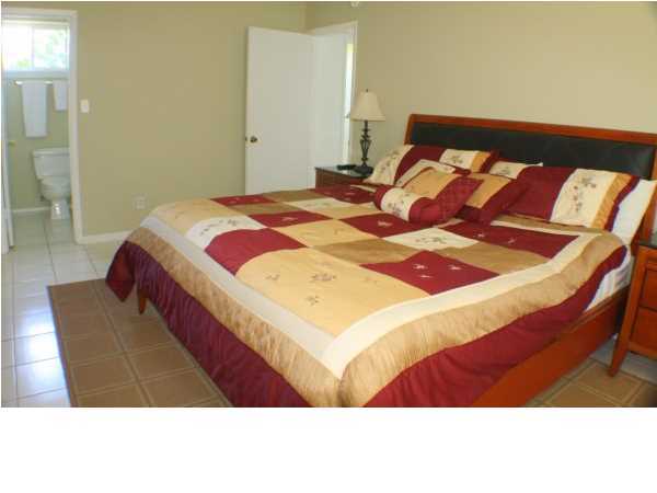 556 Blue Mountain Beach Road Santa Rosa Beach, FL 32459 - Photo 11 of 14 a bedroom with a bed and a night stand
