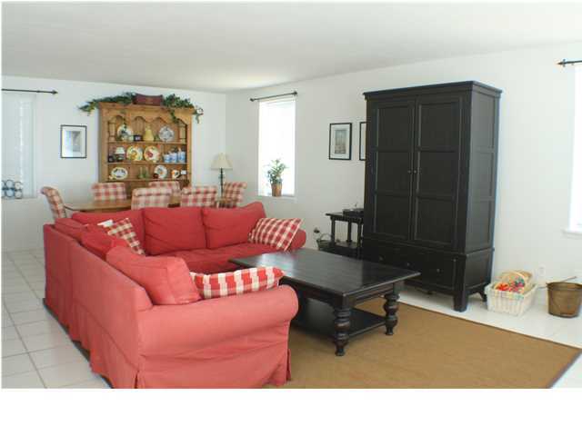 556 Blue Mountain Beach Road Santa Rosa Beach, FL 32459 - Photo 4 of 14 a living room with furniture and a table