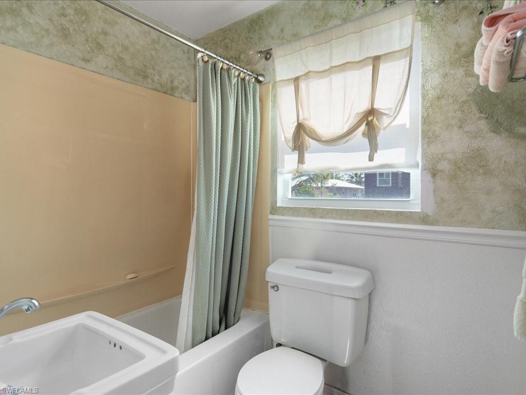 565 Coconut Avenue Goodland, FL 34140 - Photo 17 of 35 Full bathroom featuring toilet, sink, and shower / bath combo with shower curtain