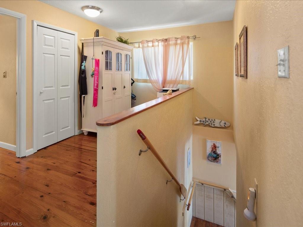 565 Coconut Avenue Goodland, FL 34140 - Photo 19 of 35 Staircase featuring hardwood / wood-style flooring