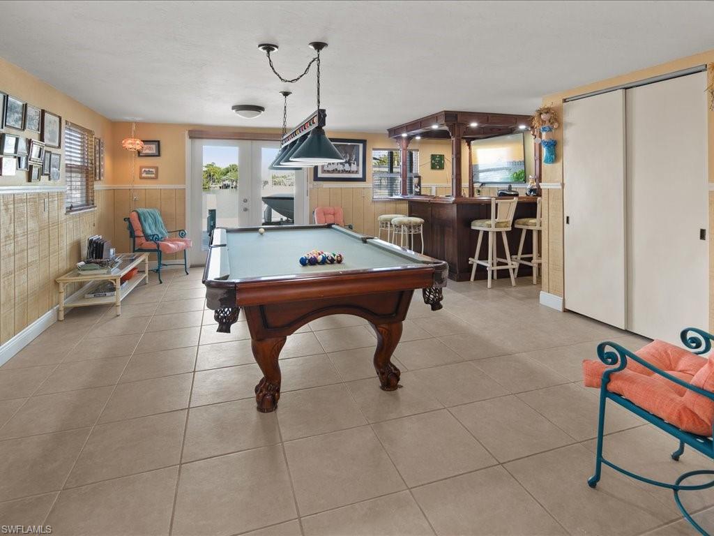 565 Coconut Avenue Goodland, FL 34140 - Photo 20 of 35 Rec room with bar, pool table, french doors, and light tile patterned flooring
