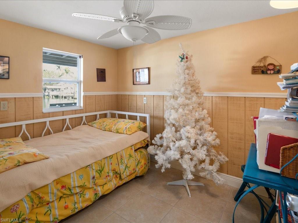 565 Coconut Avenue Goodland, FL 34140 - Photo 24 of 35 Bedroom featuring tile patterned floors and ceiling fan