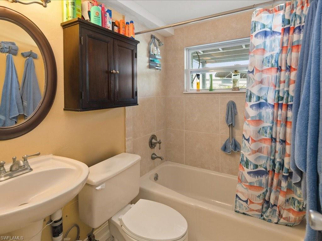565 Coconut Avenue Goodland, FL 34140 - Photo 25 of 35 Full bathroom featuring toilet, sink, and shower / bath combo