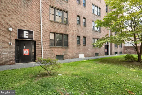 a view of an empty room with wooden floor and windows