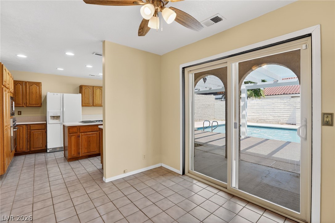 3698 Laughlin Boulevard Laughlin, NV 89029 - Photo 25 of 49 A well-equipped kitchen transitions seamlessly to an outdoor living area with a sparkling pool.